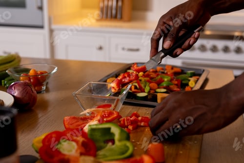 Preview: Hands of african american man preparing meal in kitchen