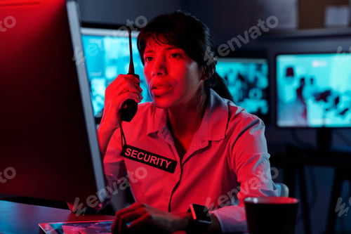 Preview: Young female officer using walkie-talkie