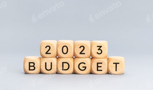 Preview: 2023 budget message on wooden cube shape on blue background