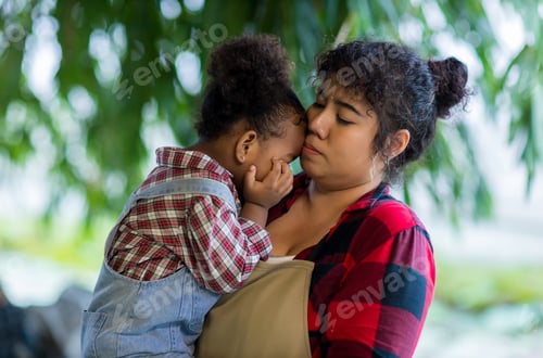 Preview: Mother holds her daughter in her arms, watching him lovingly in the vegetable garden.