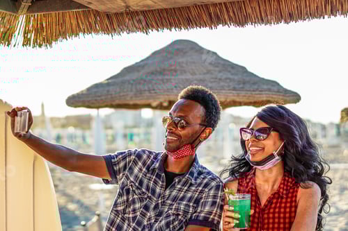 Preview: African american couple taking selfie in beach party