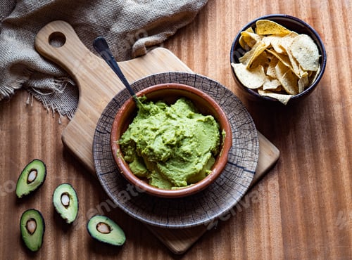 Preview: Bowl of guacamole on a wooden background. Concept: healthy food