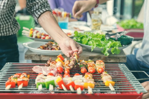 Preview: A man grilling pork and barbecue in dinner party. Food, people and family time concept.