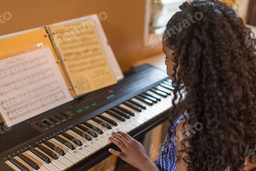 Preview: Over shoulder view of girl playing keyboard