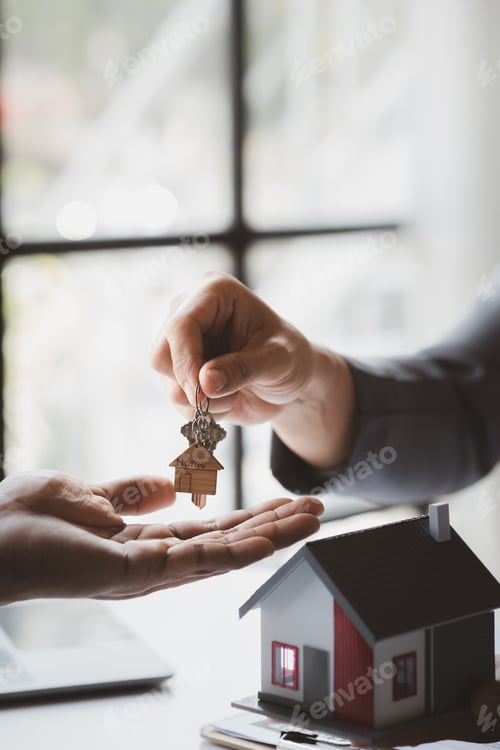 Preview: A home rental company employee is handing the house keys.
