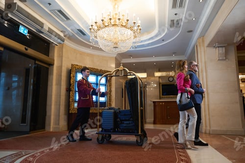 Preview: Traveling couple walks through foyer of luxury hotel in everyday life