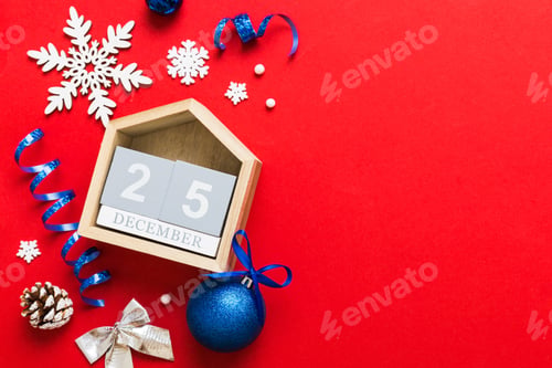 Preview: Christmas calendar 25 december. Christmas gift, fir branches, pine cones. Flat lay, top view.