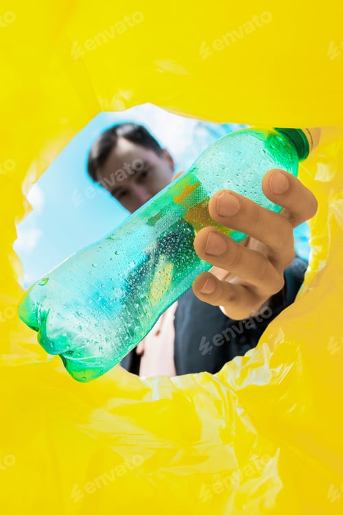 Preview: Man throwing a bottle into a trash can