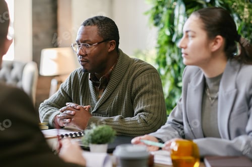 Preview: Middle Aged Black Man and Young Adult Caucasian Woman Attending Business Meeting