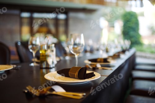 Preview: Sparkling glassware stands on long table prepared for wedding dinner.