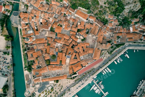 Preview: Red roofs of the ancient town of Kotor on the shore of the bay. Montenegro. Drone