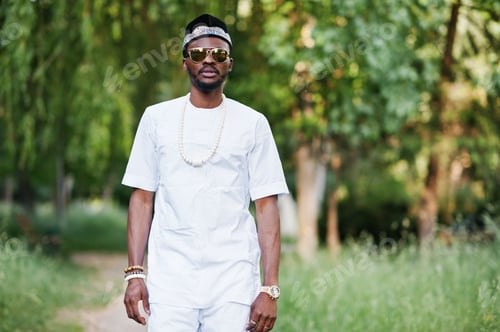 Preview: Portrait of stylish and rich black african american man on white clothes, sunglasses and hat