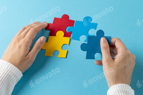 Preview: Composition of hands putting jigsaw puzzle pieces together on blue background with copy space
