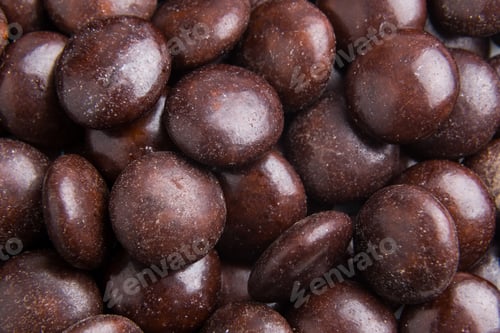 Preview: Close up on pile brown milk chocolate candies crisp shell