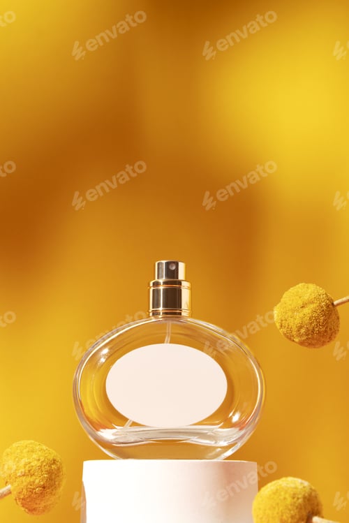 Preview: Perfume bottle with white label and craspedia flowers. Concept of expensive perfume and cosmetics
