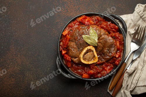 Preview: Traditional Italian dish Ossobuco all Milanese made with cut veal shank meat with vegetable tomato