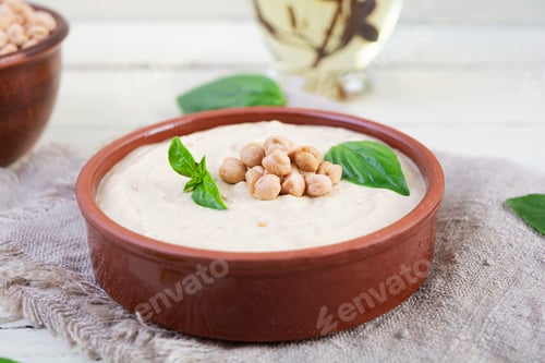 Preview: Eggplant hummus in a plate with basil. Chickpea dishes. Vegetarian food