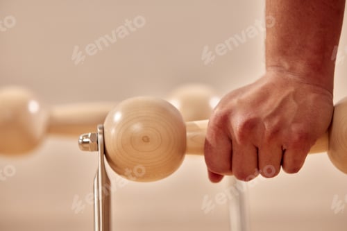 Preview: Man doing a handstand push-up using floor bars balancing on his hands. Fitness concept