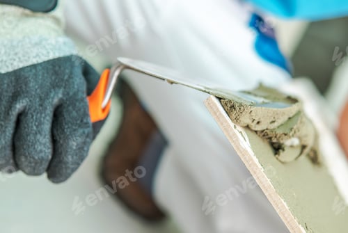 Preview: Worker Applying Plaster With a Trowel During Renovation in a Home Interior