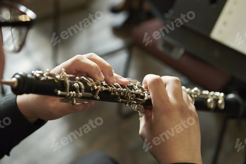 Preview: Closeup of a person playing the oboe, indoors