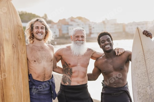 Preview: Multi generational surfer men smiling on camera on the beach