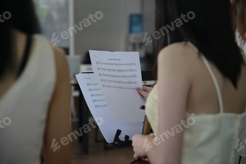 Preview: Young women musician is online training lesson classes playing guitar at home and play music.
