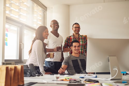 Preview: Laughing woman and men at computer in office
