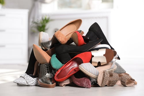 Preview: Pile of female shoes on floor indoors