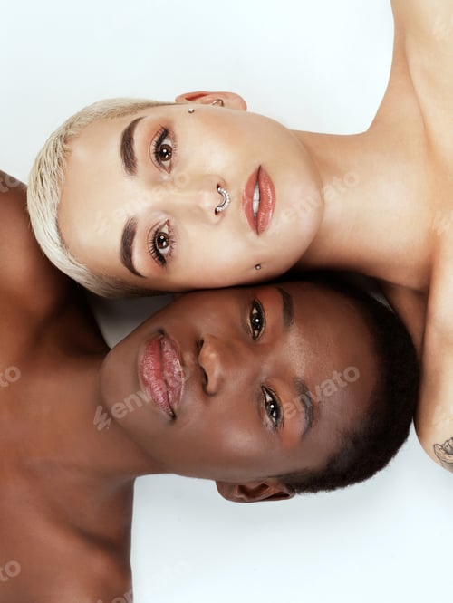 Preview: Studio portrait of two beautiful young women against a grey background