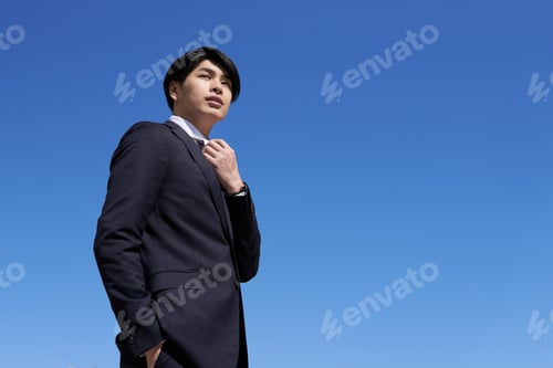 Preview: A Japanese male businessman with a blue sky background