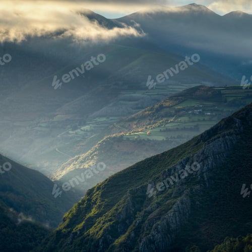 Preview: Tangential rays of the dawn sun illuminate villages and meadows between steep slopes