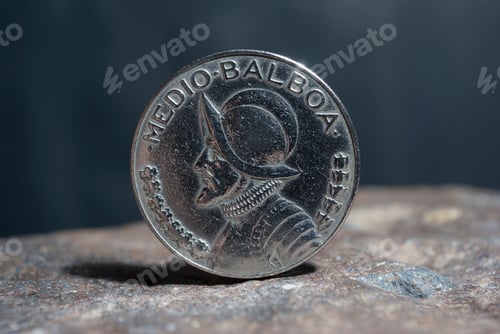 Preview: Closeup of a silver 1 Dollar 1994 Hong Kong on the rocky surface with a dark background