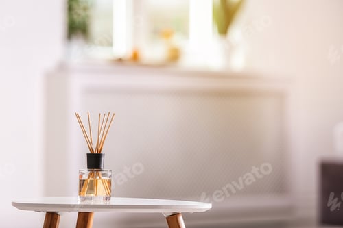 Preview: Aromatic reed air freshener on table against blurred background