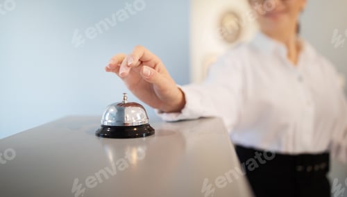 Preview: Unrecognizable Businesswoman Pushing Call Bell At Reception Counter Standing Indoors