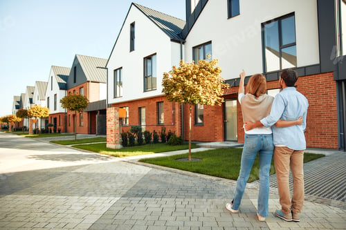 Preview: Couple Embracing in Front of Suburban Brick Homes