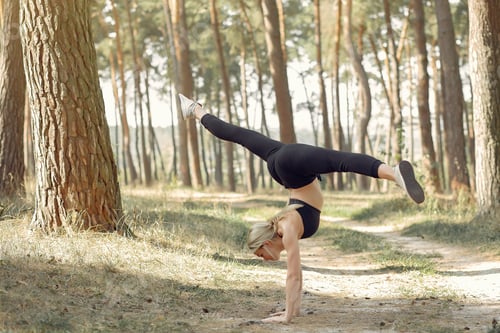 Preview: Cute girl doing yoga in a summer forest