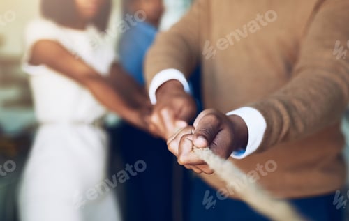 Preview: Cropped shot of corporate businesspeople pulling on a rope during tug of war
