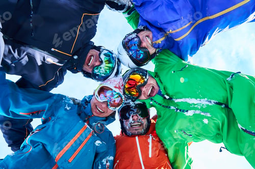 Preview: Low angle portrait of circle of skiers in helmet and goggles, Aspen, Colorado, USA