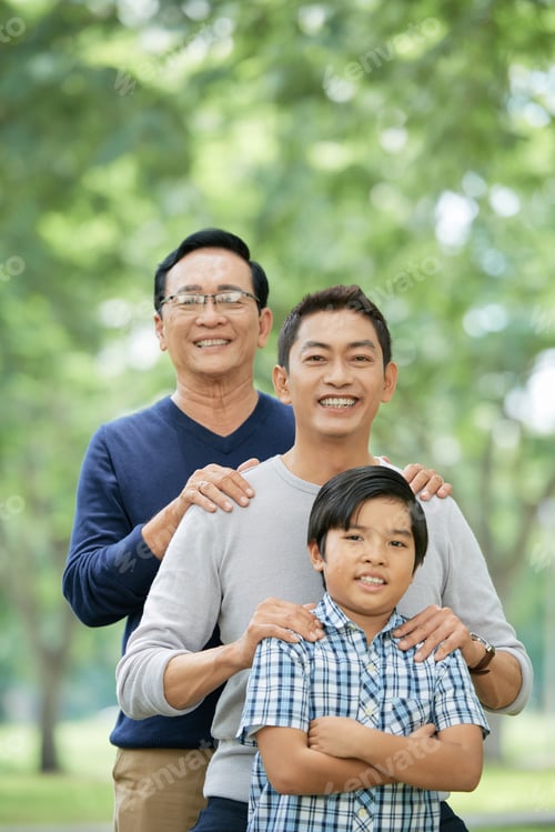 Preview: Confident Asian boy with father and grandfather in park