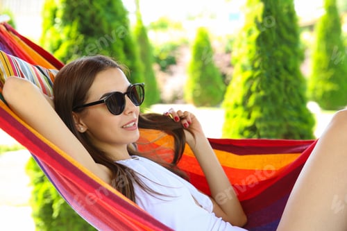 Preview: Woman Relaxing in a Hammock in the Garden