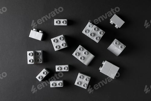 Preview: Gray details of toy constructor on black background, top view