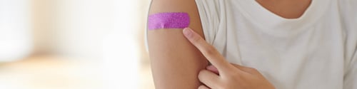 Preview: Girl Pointing at Pink Bandage on Arm
