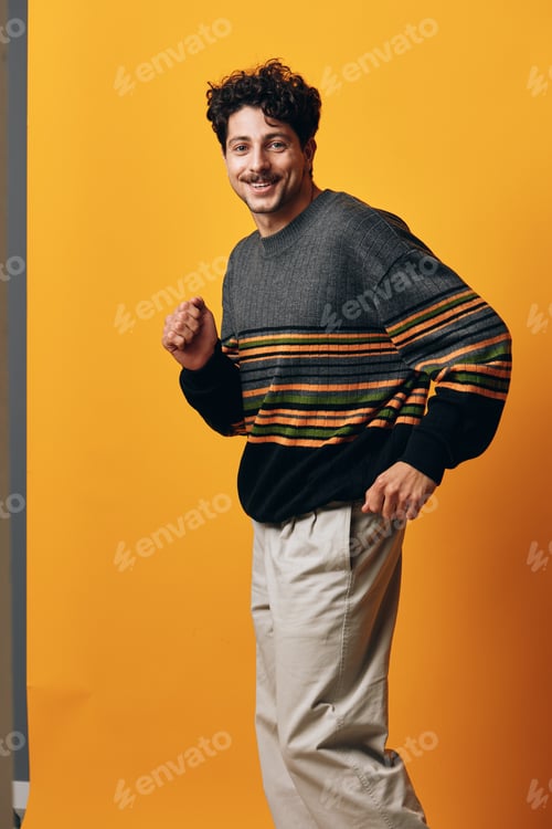 Preview: Happy man smile portrait student serious sweater studio guy background fashion expression orange