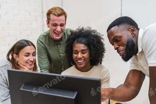 Preview: Coworkers laughing and collaborating on computer project