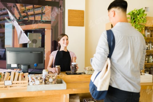 Preview: Friendly cashier with a young man at the store