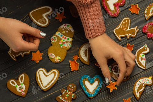 Preview: Decorating Festive Gingerbread Cookies on Wooden Table