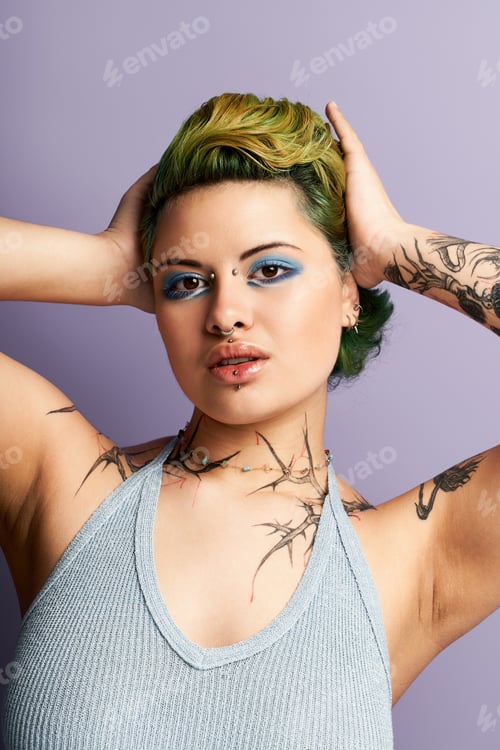 Preview: Vibrant young woman showcasing edgy fashion and bold makeup in a trendy studio setting