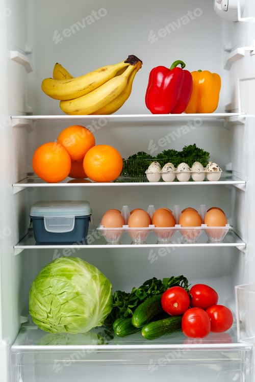 Preview: White Refrigerator Open With Fresh Produce and Dairy