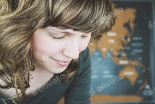 Preview: Wanderlust concept image of a woman near a world map