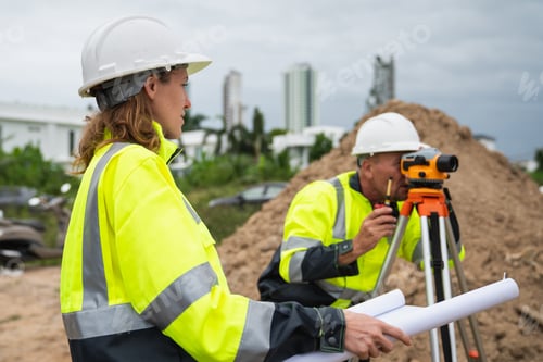 Preview: The survey team is using a theodolite and road construction plans.